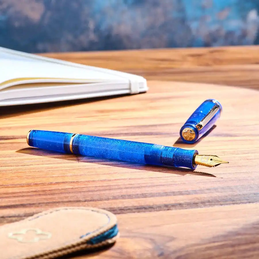 Blue fountain pen with gold nib.