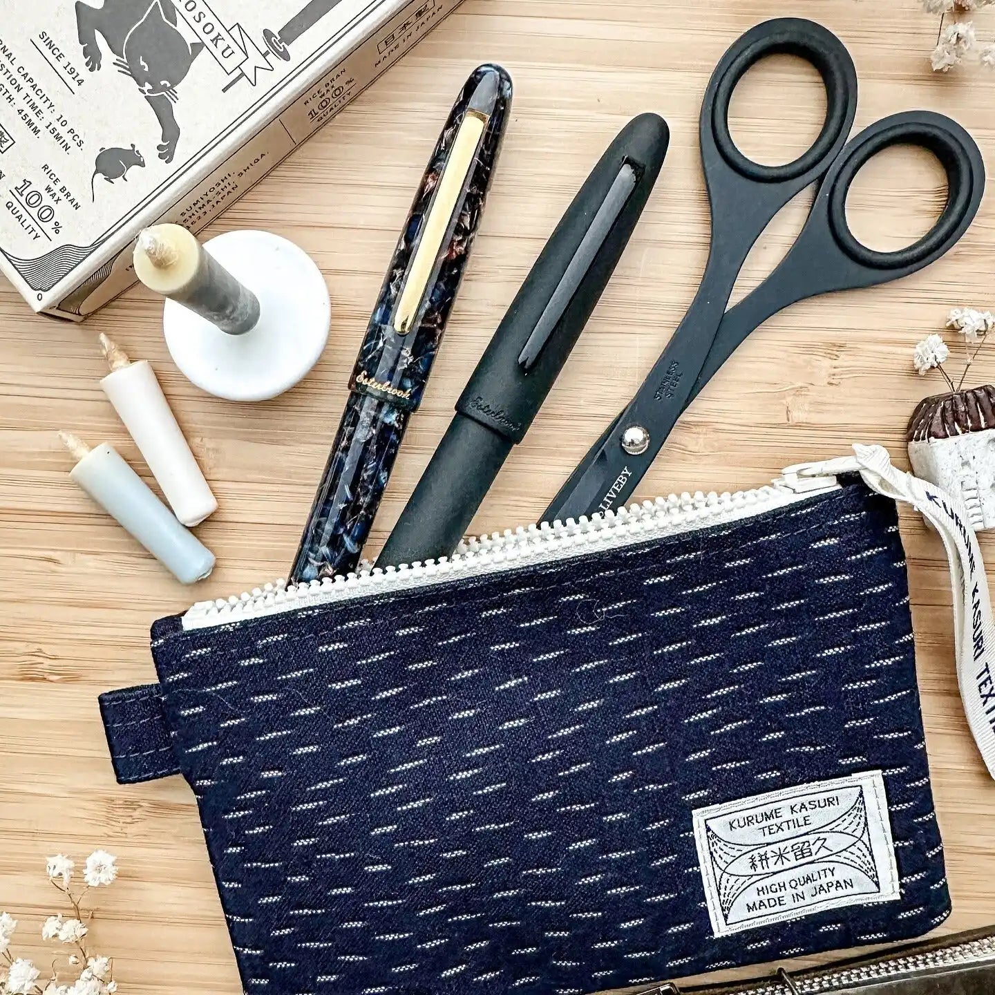 Navy blue patterned zipper pouch.